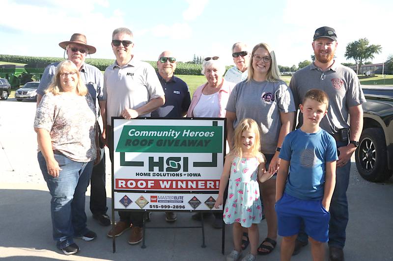 Brett and Katie Stender of Greenfield, and children Clara and Oliver, accept the gift of a new roof for their home from the Community Heroes Roof Giveaway Contest from Home Solutions of Iowa.