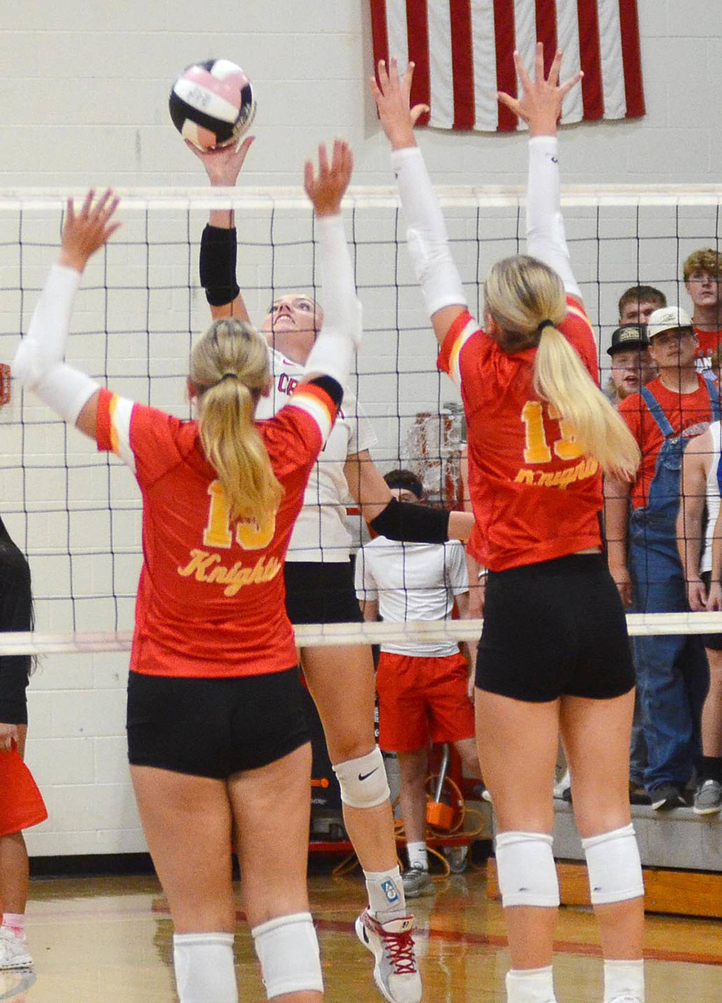 Hollynn Rieck of Creston looks for an opening against two Kuemper blockers. Rieck finished with five kills and nine digs.