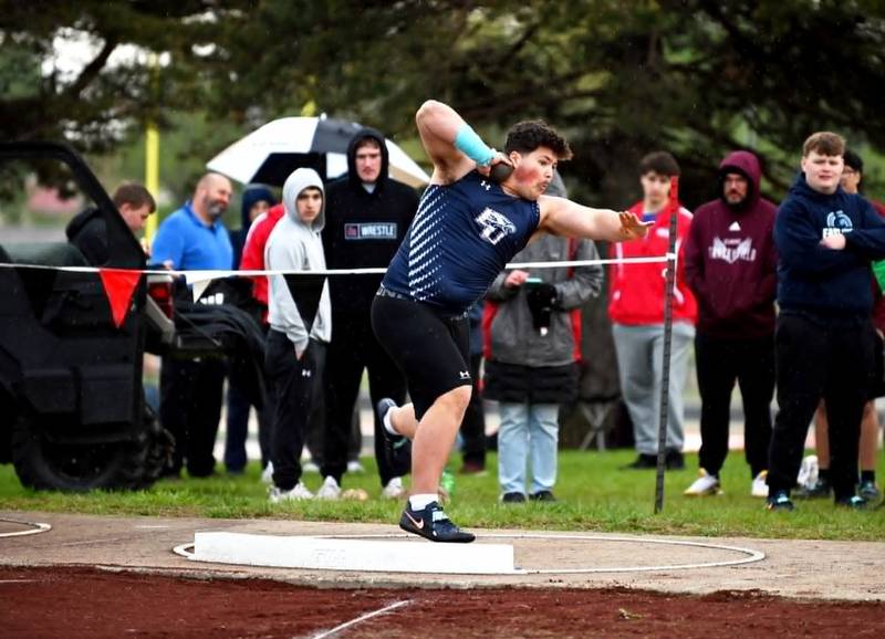 Morgan Cooley of East Union winds up for a throw in shot put Tuesday in Mount Ayr. He won the event with a mark of 59-07, setting a new meet record.