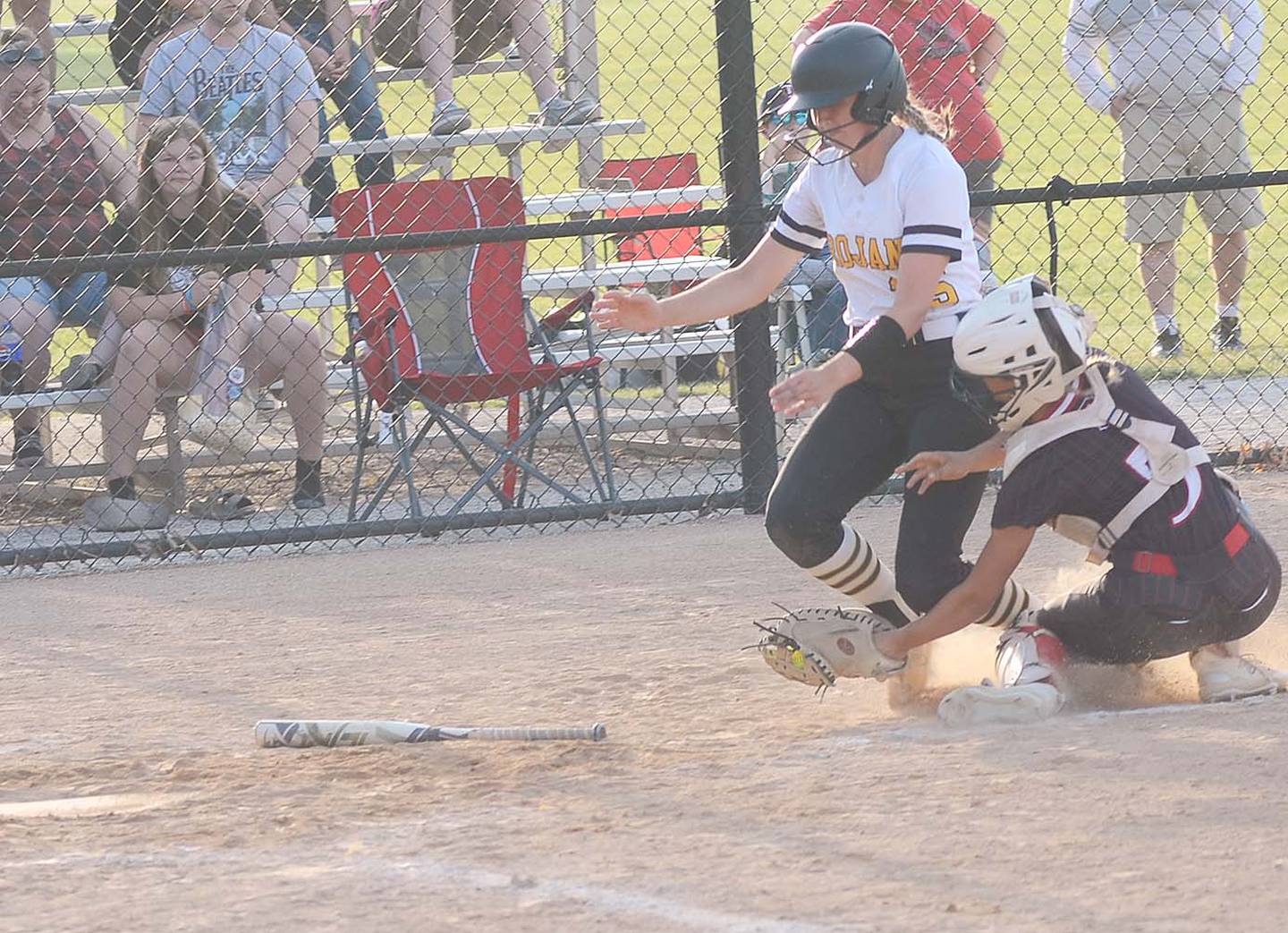 Atlantic's Jillian Saathoff was ruled safe at home plate after Creston catcher Ava Adamson caught a relay throw from shortstop Avery Staver on a Trojan base hit in the sixth inning of Creston's 12-10 victory.