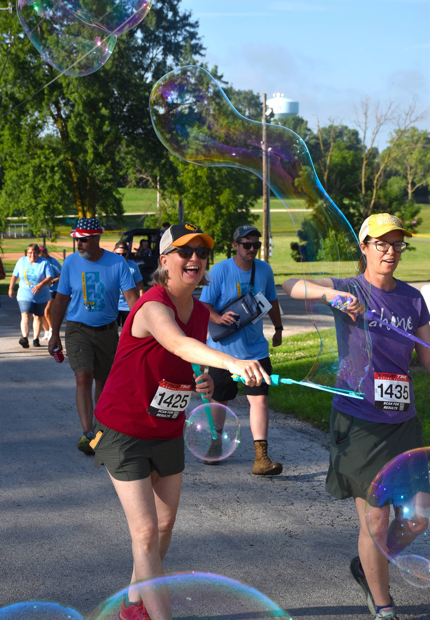 5K participants share the joy of bubbles at the start of the Greater 8 and 5K race Saturday morning.