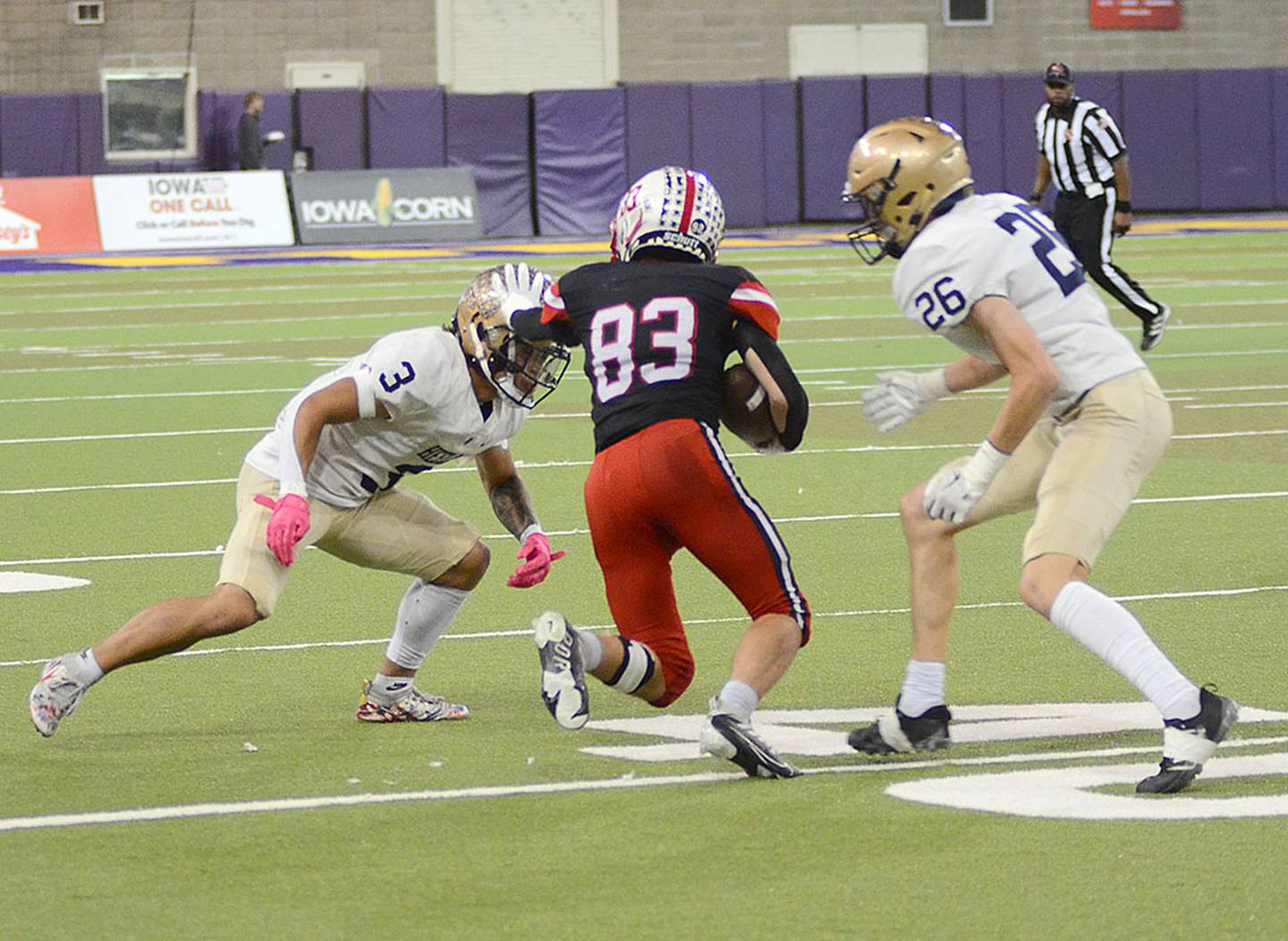 Creston receiver Brandon Briley (83) splits two Bishop Heelan defenders, Sir Brandon Watts (3) and Brady Baker (26) to pick up yardage on one of his 11 receptions Saturday. Briley had 101 receiving yards Saturday, pushing his single-season school record to 897 yards. Teammate Brennan Hayes is second all-time with 881 yards receiving this season.