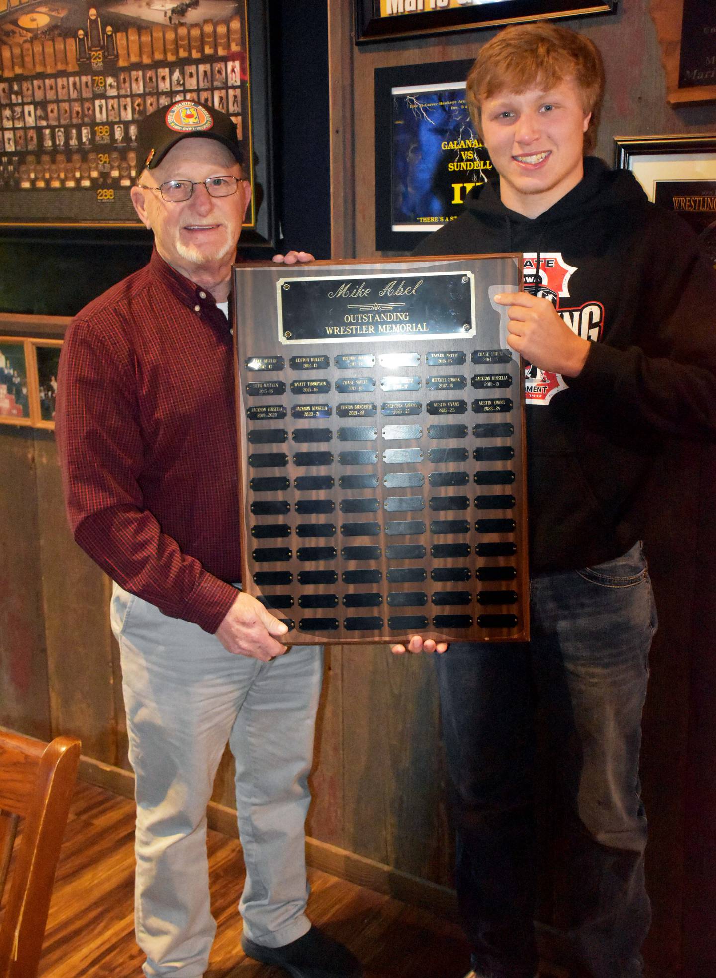 Denny Abel presents the Mike Abel Outstanding Wrestler award to senior Austin Evans.