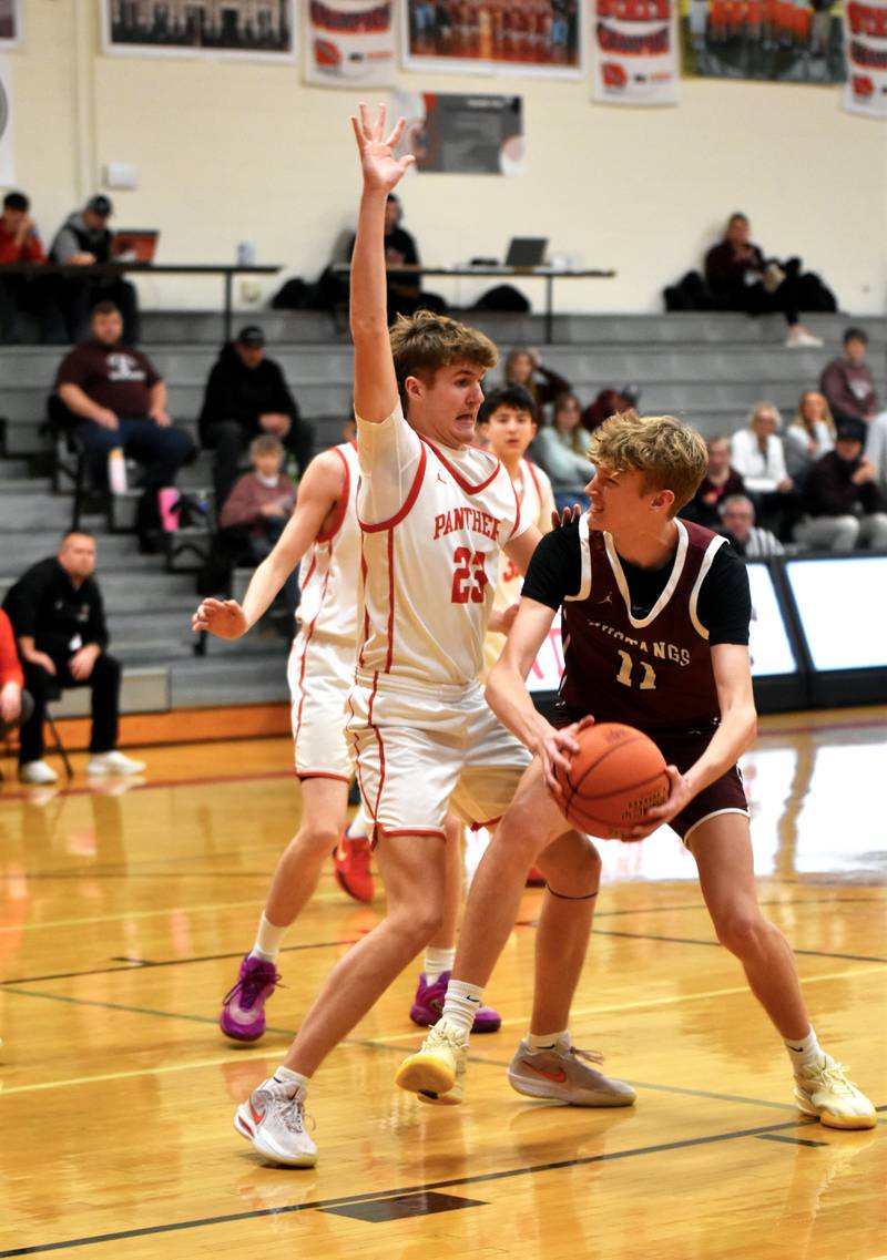 Creston’s Baret Lane defends the basket against Shenandoah’s 6-8 center Brody Burdorf.  Lane snagged four rebounds during the contest.
