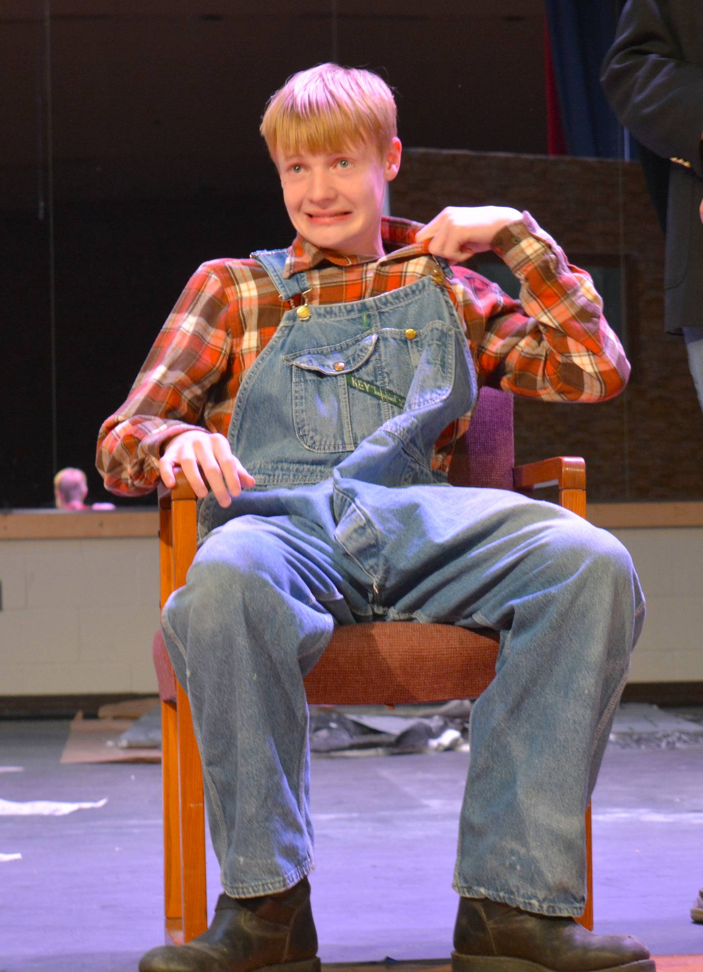 Noah Richardson pulls at his collar while performing in "I Hate Shakespeare."