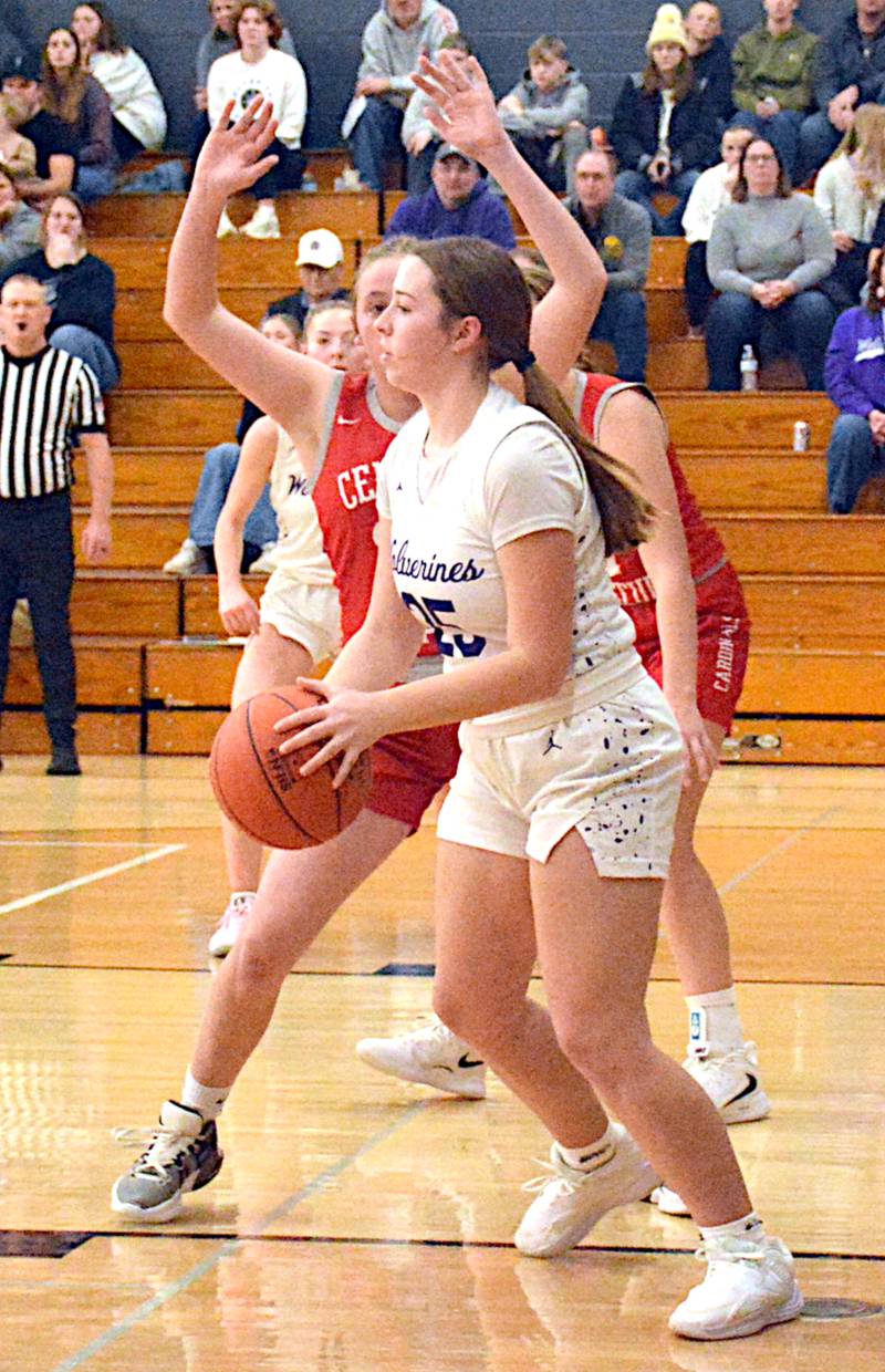 NV senior Lea Stonebraker looks for an open teammate from the low block, facing Central Decatur's defense Friday night.