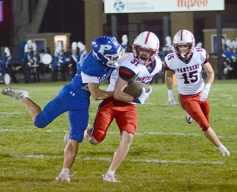 Dylan Calvin of Creston returns one of his two interceptions in Friday's 49-14 win at Perry. Trailing the play is safety McCoy Haines, who also had two interceptions in the game.