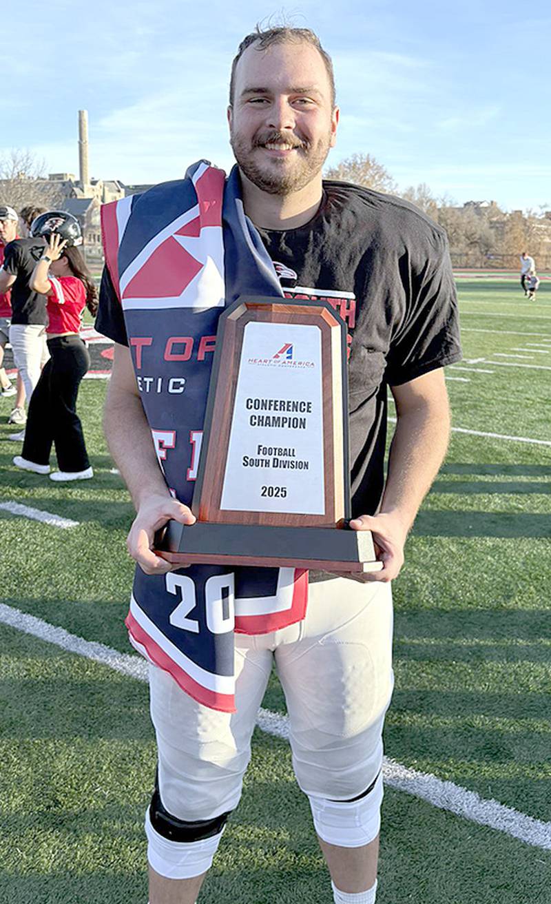 Benedictine offensive tackle Avery Fuller of Creston holds the Heart of America South Division championship trophy after the Ravens completed a 10-1 regular season. Benedictine is a No. 5 seed in the NAIA playoffs on Nov. 29.