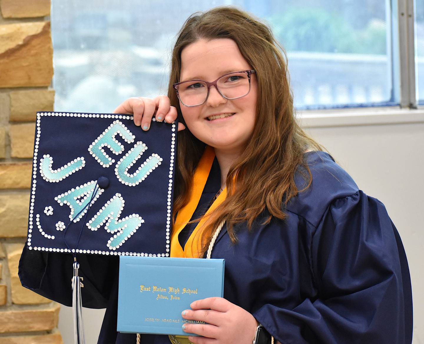 Joselyn McWilliams shows her designed graduation cap.