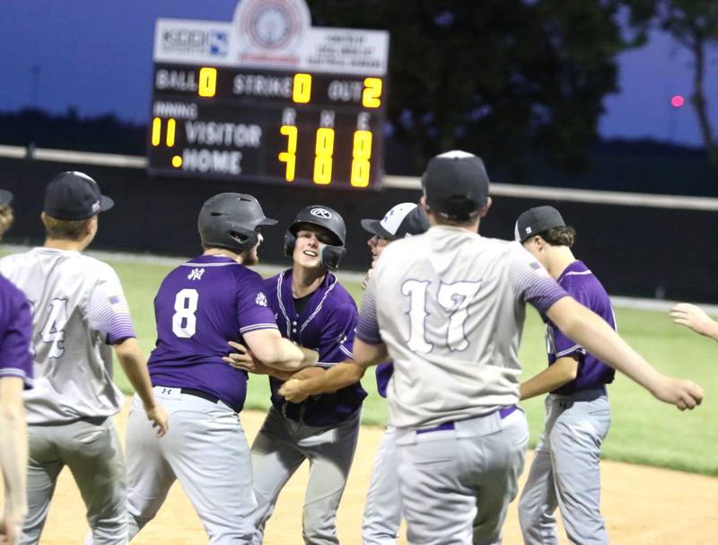The Nodaway Valley/OM baseball team celebrates winning an 11-inning marathon with Wayne Friday, June 27 at home.