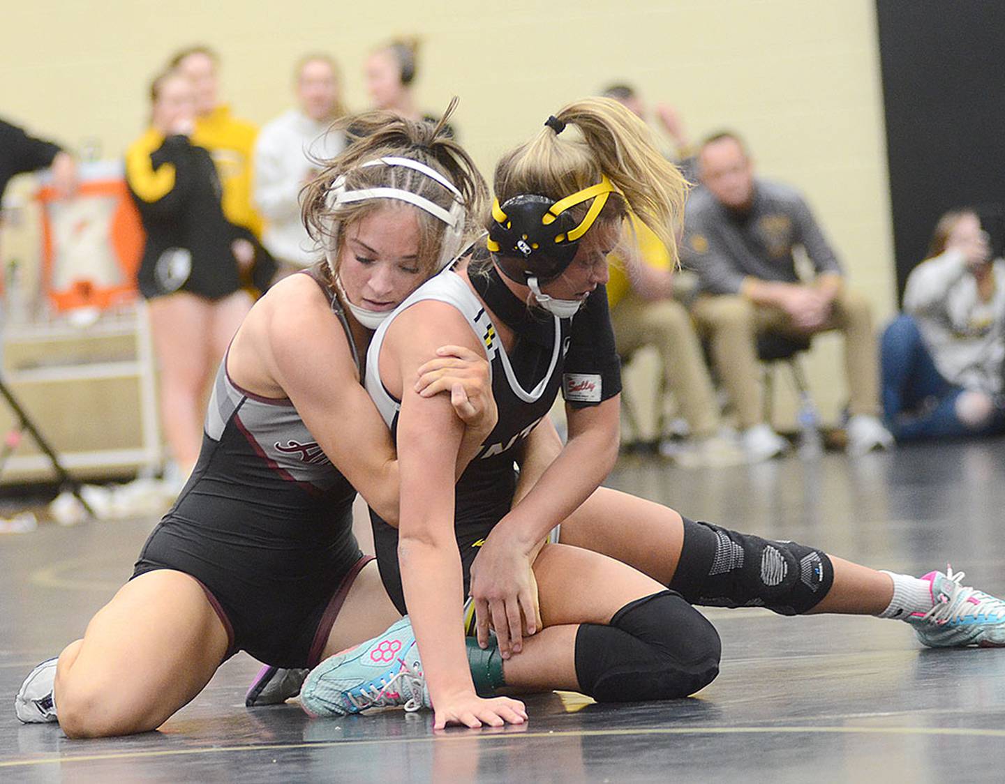 Ankeny's Karlie Kruse (left), former Creston wrestler, controls Charlee Kounkel of Hinton/Sergeant Bluff-Luton during the 125-pound finals. Kruse won by fall, handing Kounkel her first loss of the season.