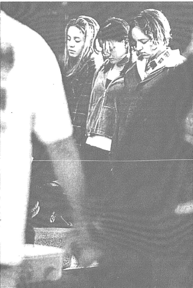 *Creston High School students sophomore Michelle Vertanen, junior Jessie Davis and senior Amanda James join in prayer outside the high school this morning. About 35 students read Bible verses and prayed as part of “See you at the Pole,” an annual event where students pray at their school flag-pole before school begins.