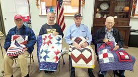 Four who served accept quilts