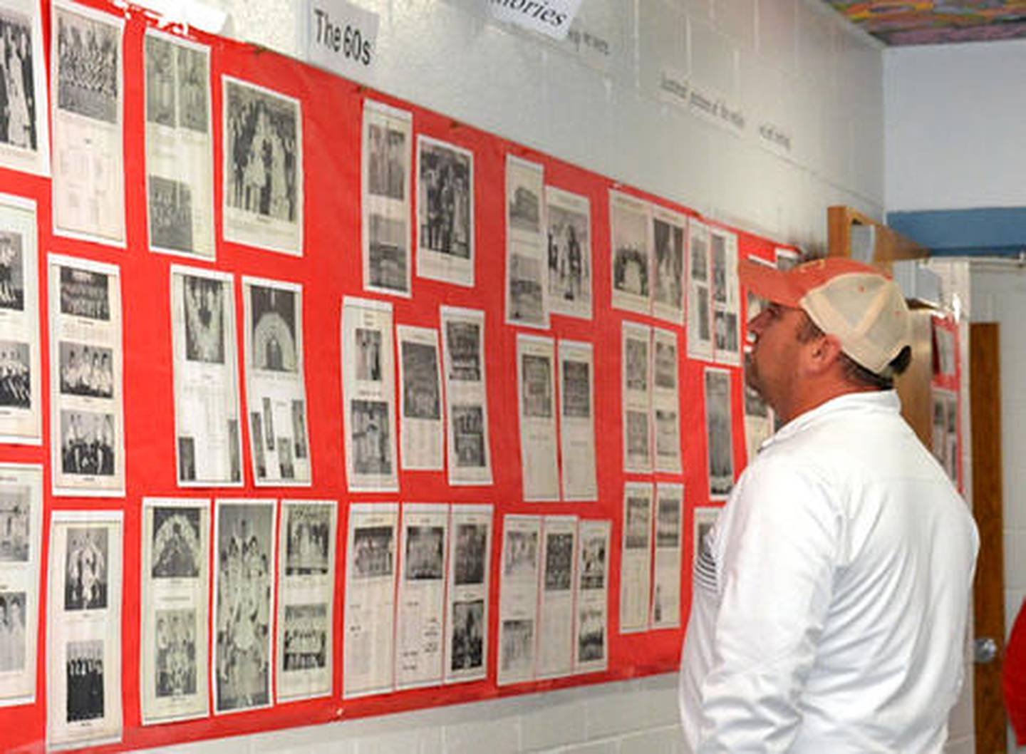 Galen Geidel looks at a display of yearbook pages. More than 400 people attended the event where memorabilia could be viewed and stories shared.