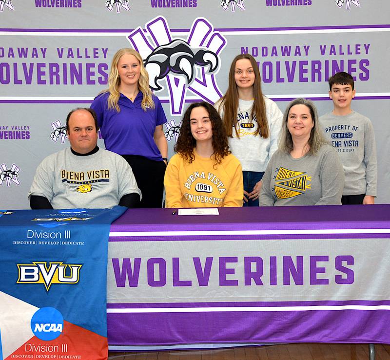 Genevieve Livingston signs with Buena Vista University volleyball, surrounded by parents Warren and Renea, siblings Adelaide and Truman, and Nodaway Valley head volleyball coach McKynli Newbury.