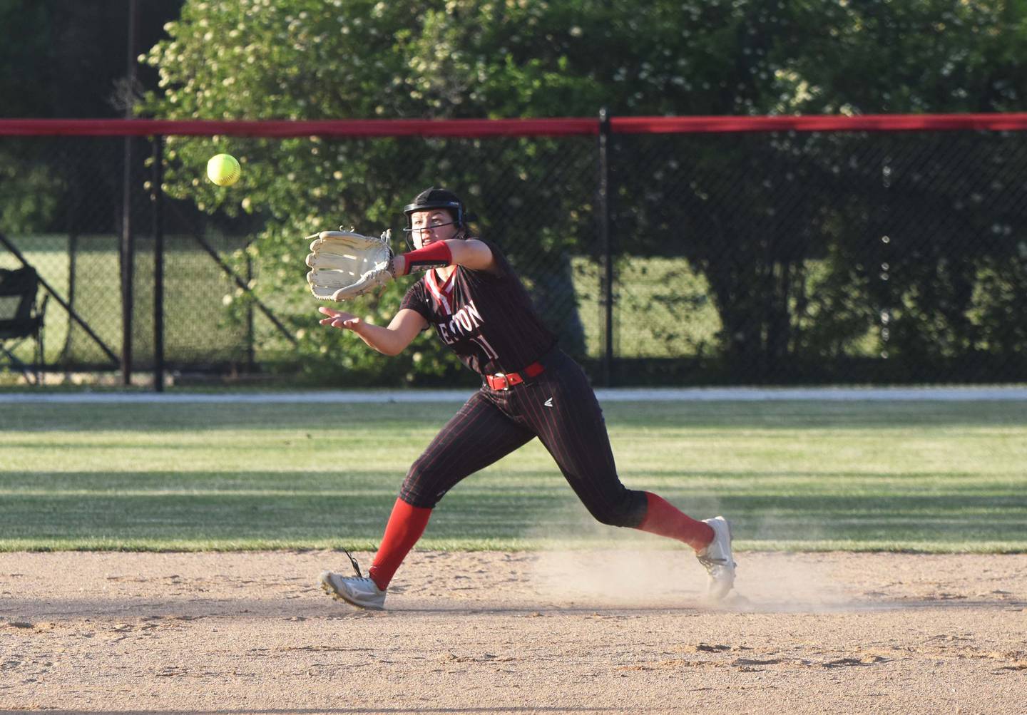 Mila Kuhns lunges for a ball in game two, catching it for the out.