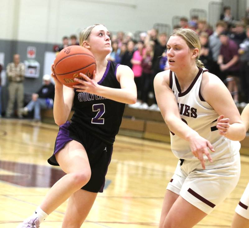 Nodaway Valley senior Maddie Weston drives to the hoop against the Shenandoah defense in a regional girls basketball game.