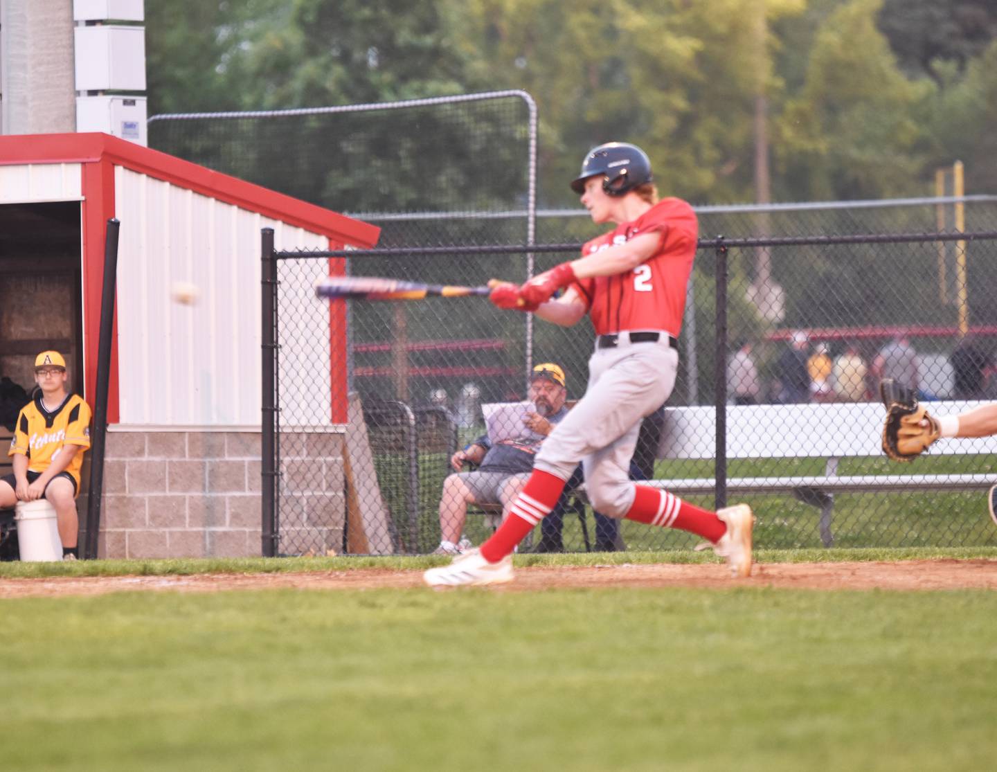 Sophomore Tanner Ray connects with a ball against the Trojans. Ray pitched a complete game, striking out nine batters.