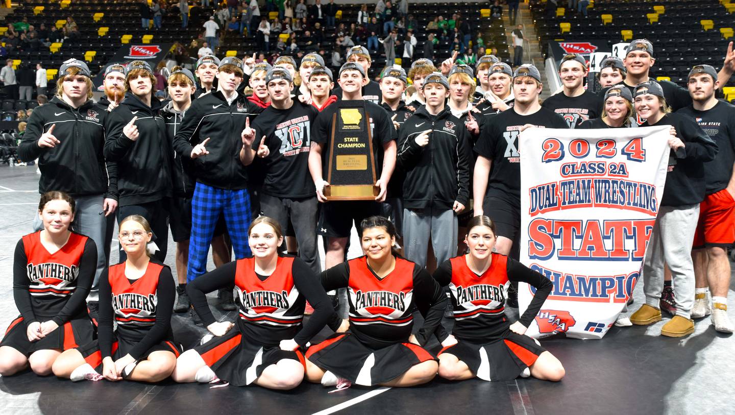 The Panthers wrestlers, managers and cheerleaders display the 2024 Class 2A Dual Team Wrestling champion trophy and banner Saturday at the Xtream Arena in Coralville after taking the title in a close 36-33 finals win over Sergeant Bluff-Luton. This team is the second Creston team to win the title, the first the 2007 team.