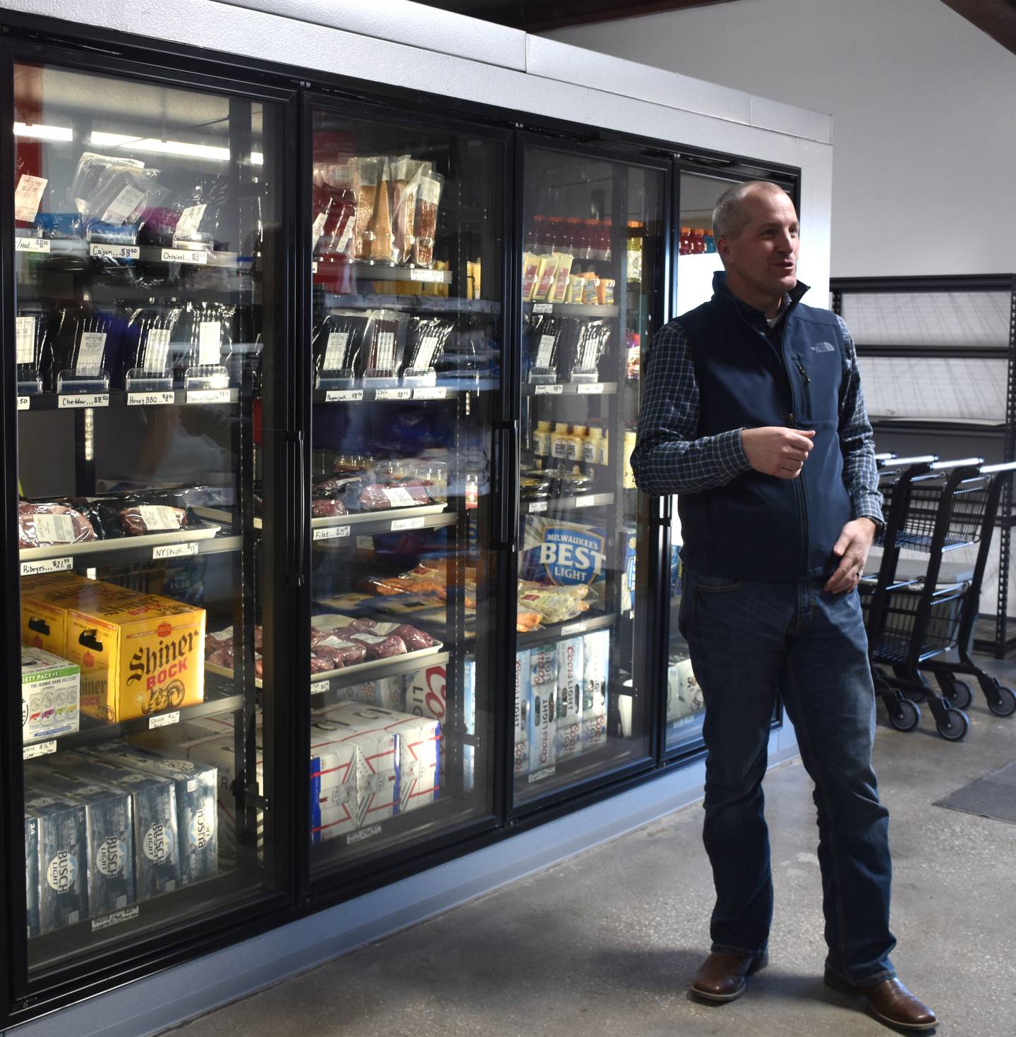 Naig chats with the Champion Steaks team about their walk-in fridge, whose installation was due to a Choose Iowa grant a few years ago.