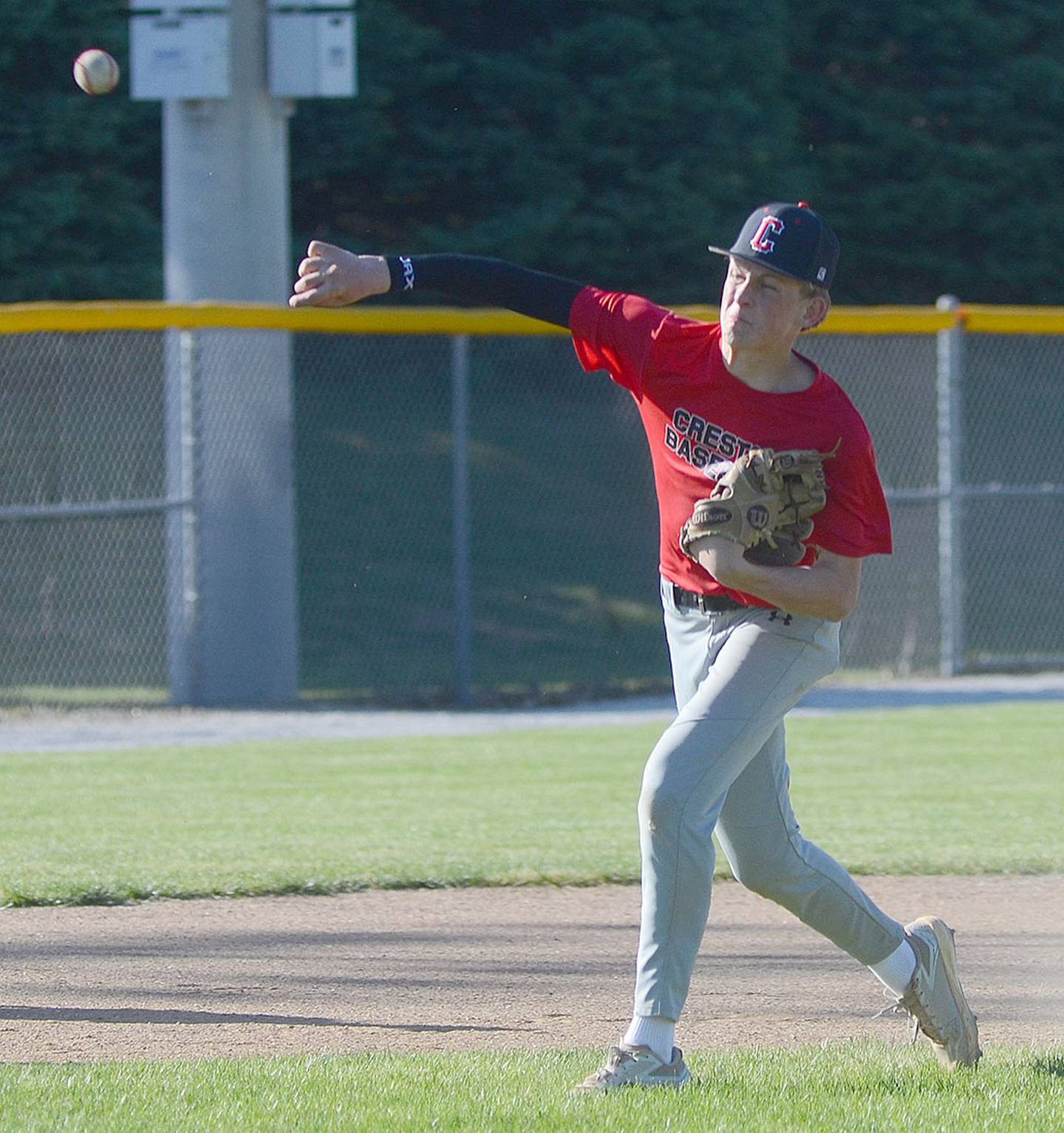 Landyn Scherer completes a relay throw from third base to home plate during a fielding drill. Scherer is slated for infield and pitching duty this season.