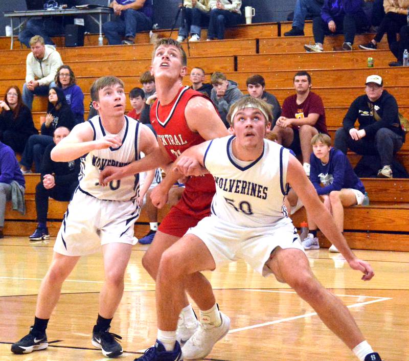 Nodaway Valley seniors Titus Hamer (left) and Parker Schneider (50) box out Central Decatur's Paxton Applegate on a free throw attempt in last Friday night's game.