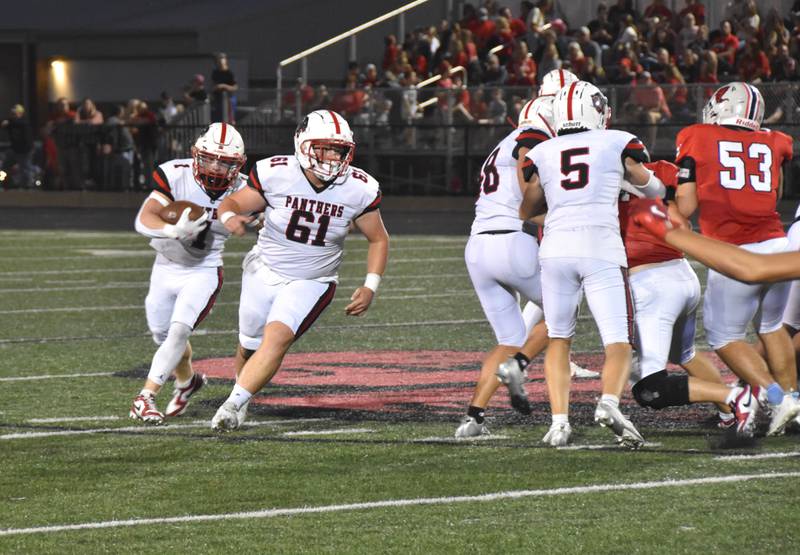 Senior running back Weston Trapp (No.1) follows blocker Garrick Clausen on a run around the right side. Trapp credits the offensive line for his career-best game Friday in a 43-42 road win over Harlan.