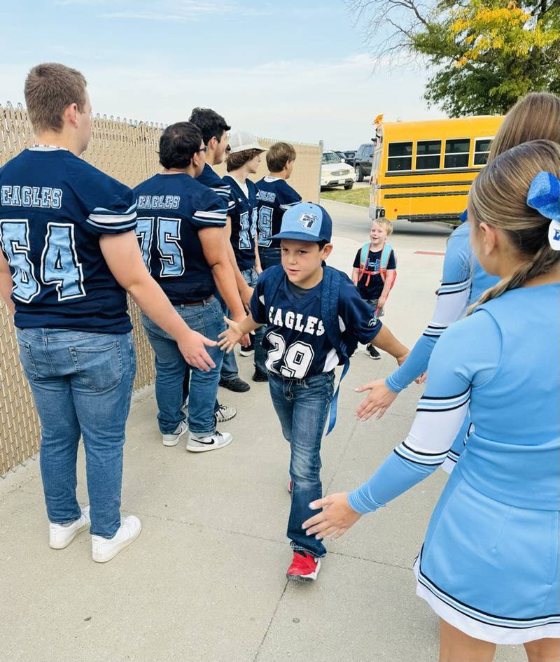 An East Union elementary student receives high fives during homecoming week's High Five Friday.