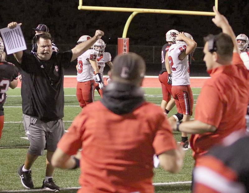 Creston head coach Brian Morrison and assistant Garrison Carter rejoice after the Panther defense held Harlan on downs late in Friday's 25-22 win. Quarterbacks coach Brandon Phipps is at center, also approaching Morrison. Carter and Morrison were opposing coaches in previous years when Carter coached ADM.