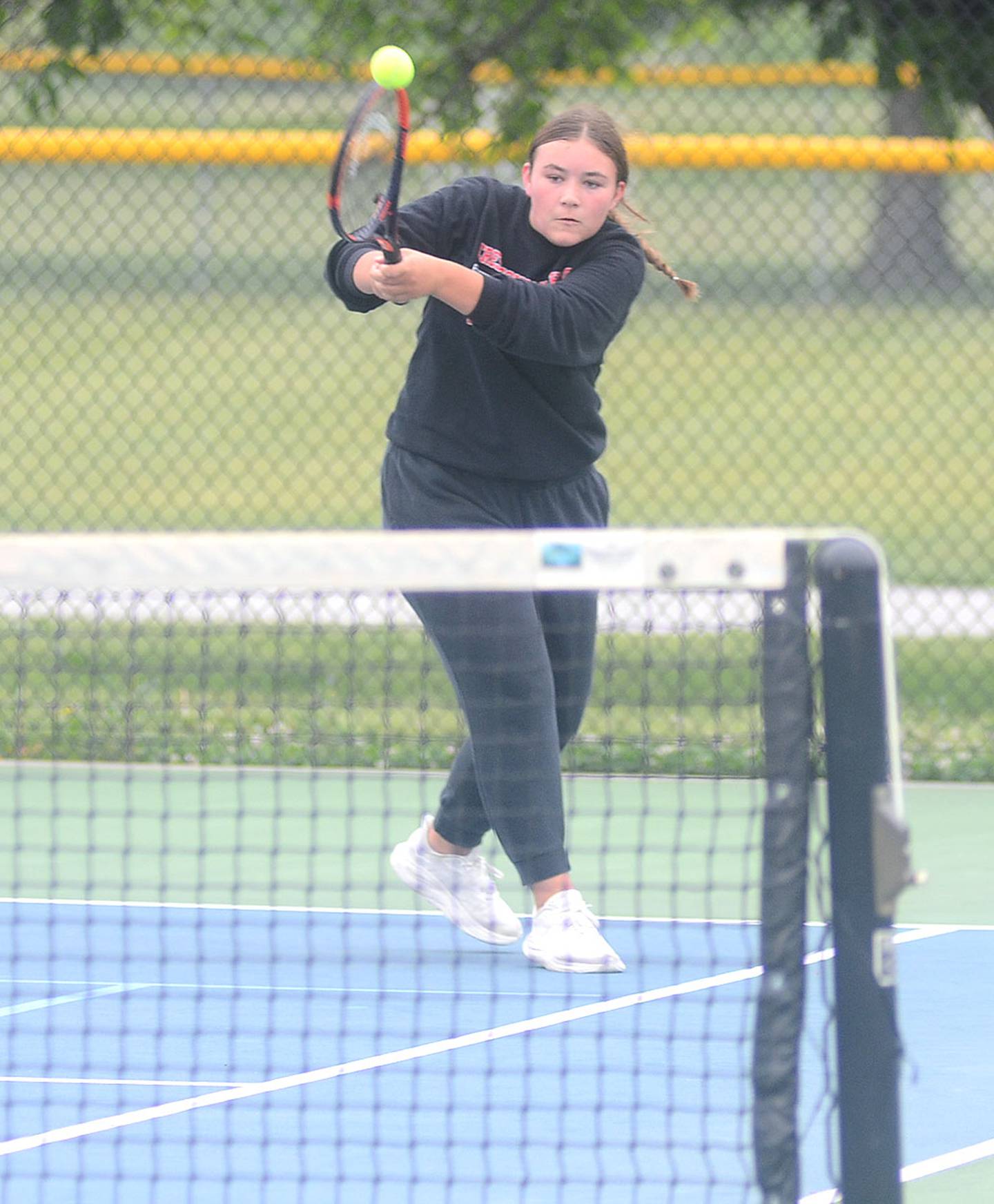 Shaylee Coen returns a backhand shot into the Clarinda court. The Panther freshman played No. 5 singles in the dual regional meet.