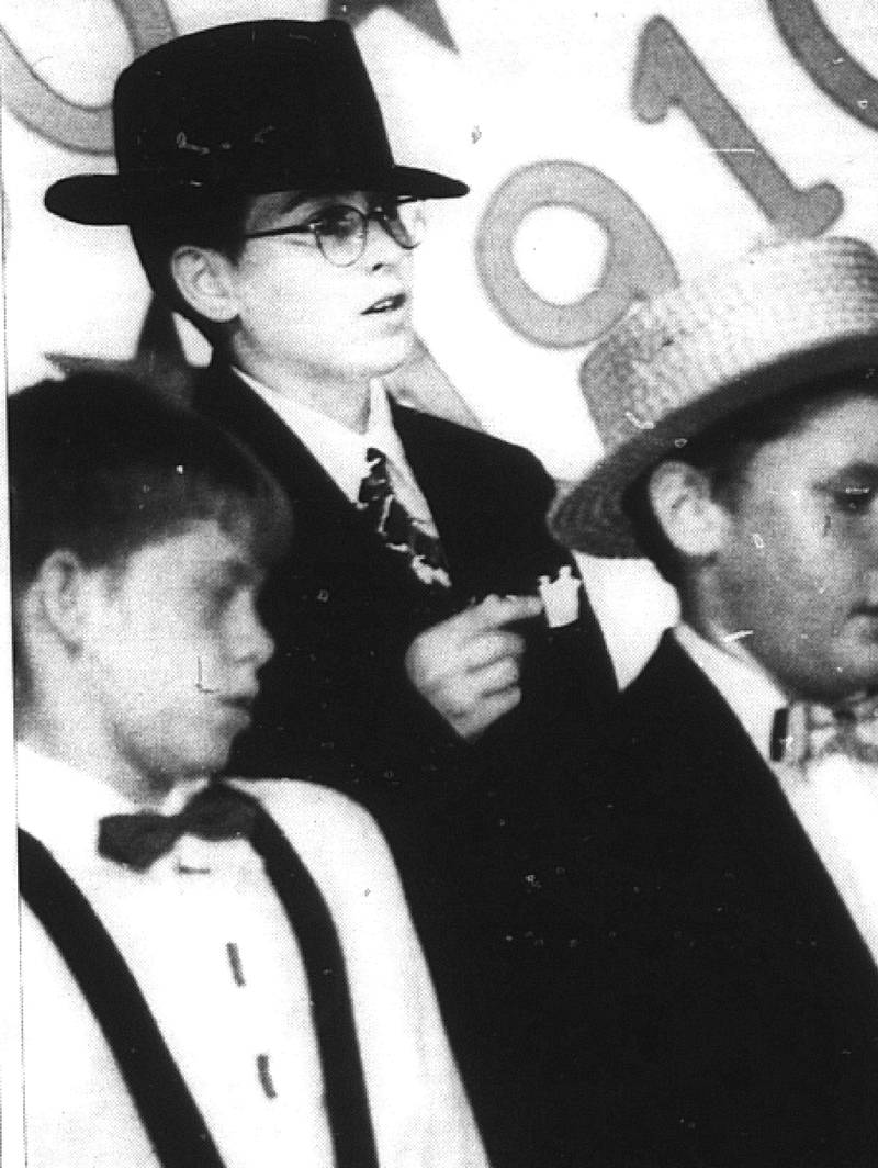 Through the years: Burton R. Hones Middle School seventh-grader James Davis, center, is all class while performing Monday night during the 20th Century choral revue at Creston High School. In the foreground are Tim Pingree and Jeff Kruse.