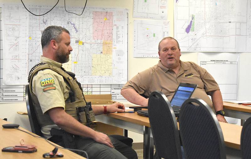 Green Valley Park Ranger Jason Hyde, left, and Union County EMA Coordinator Paul Ver Meer discuss tornado siren repairs during last week's EMA meeting.