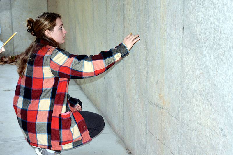 Grace Britten helps with a chalk mural outside the Warren Cultural Center this winter in Greenfield. Britten also is involved in music and was a state medalist in wrestling, all while carrying a very high GPA and a class load that involves college classes.