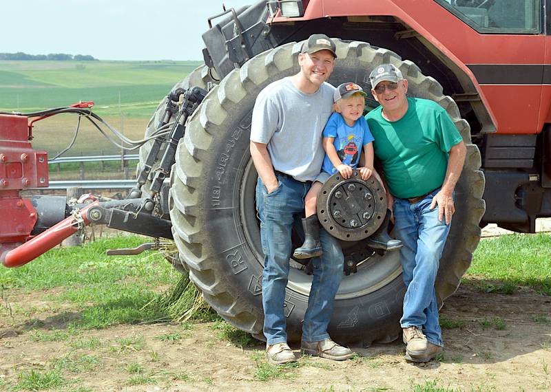 Michael and Randy Christoffersen, with young Charlie, at their farm in northern Adair County.