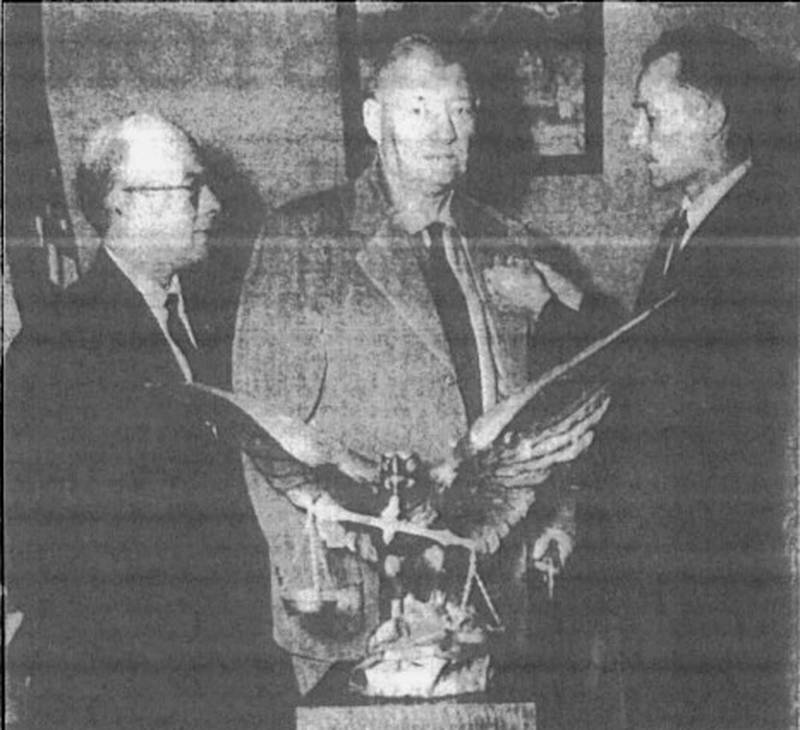 E. A. Pontow, only charter member of the Creston Eagles lodge who is still a member of the lodge, was honored at a meeting and dinner of the lodge last night. Mr. Pontow, center, is shown receiving a charter member lapel pin from Turner Vandel, right, president of the Creston aerie, while W. L. Wilkinson of Tama, left, state president of the Eagles, looks on. Pontow has been a member of the lodge since it was chartered Aug. 10, 1906.
