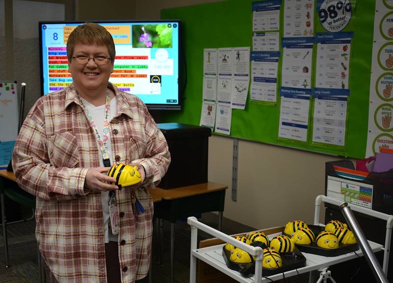 East Union computer science teacher Robin McNutt holds a Bee Bot. The small robots are programmed by students for specialized movement.
