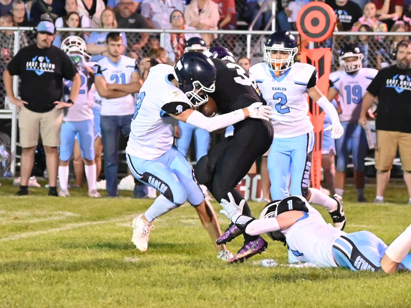 Eagles freshman Coltyn Kelley works to run through a tackle by Murray’s Wylee Wright Friday in a 64-40 East Union win.