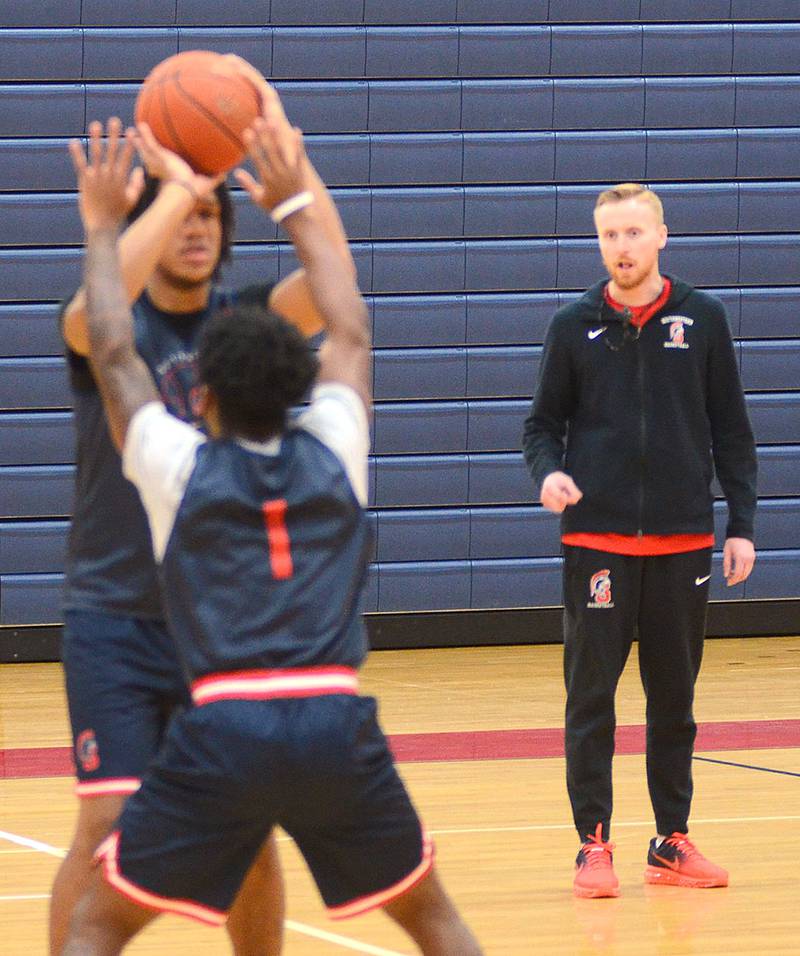 New Southwestern men's basketball coach Shane Sweany watches a drill at Monday's practice session. His Spartans open the season Wednesday night at home vs. Southeastern Community College of Beatrice, Neb.