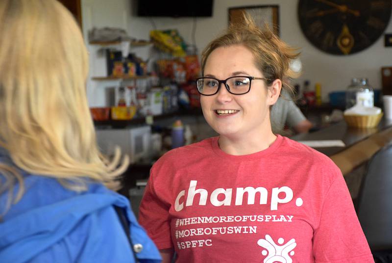 Southern Prairie Family Fitness Center Director Brianna Dillavou meets with one of the participants of the center's golf outing Friday.