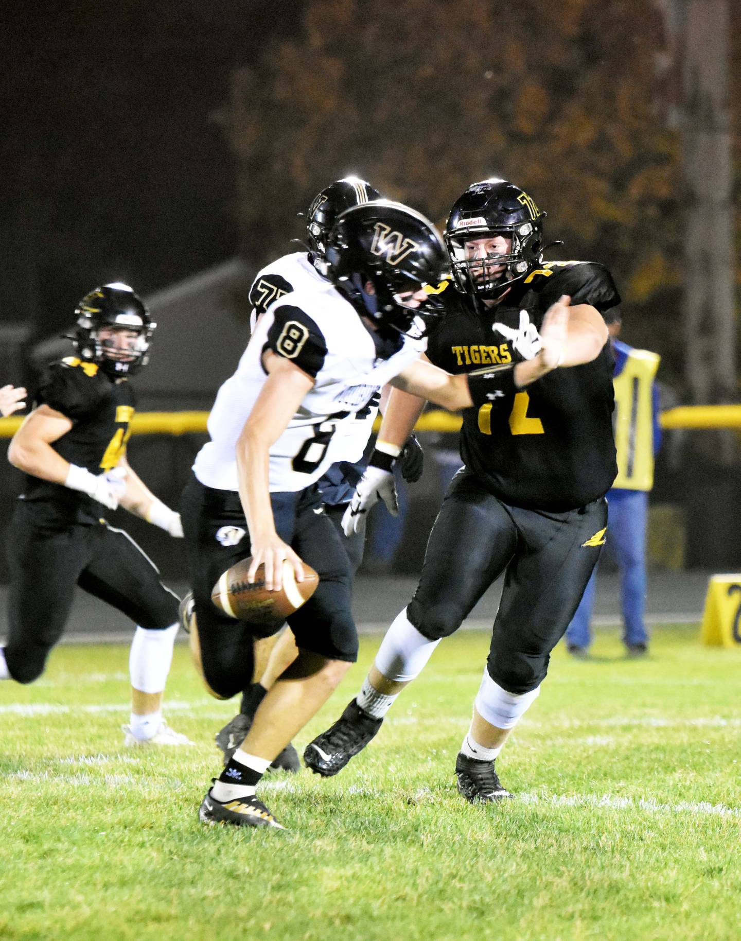 Jace Smith (No. 72) puts pressure on the Woodbine quarterback Brodyn Pryor.