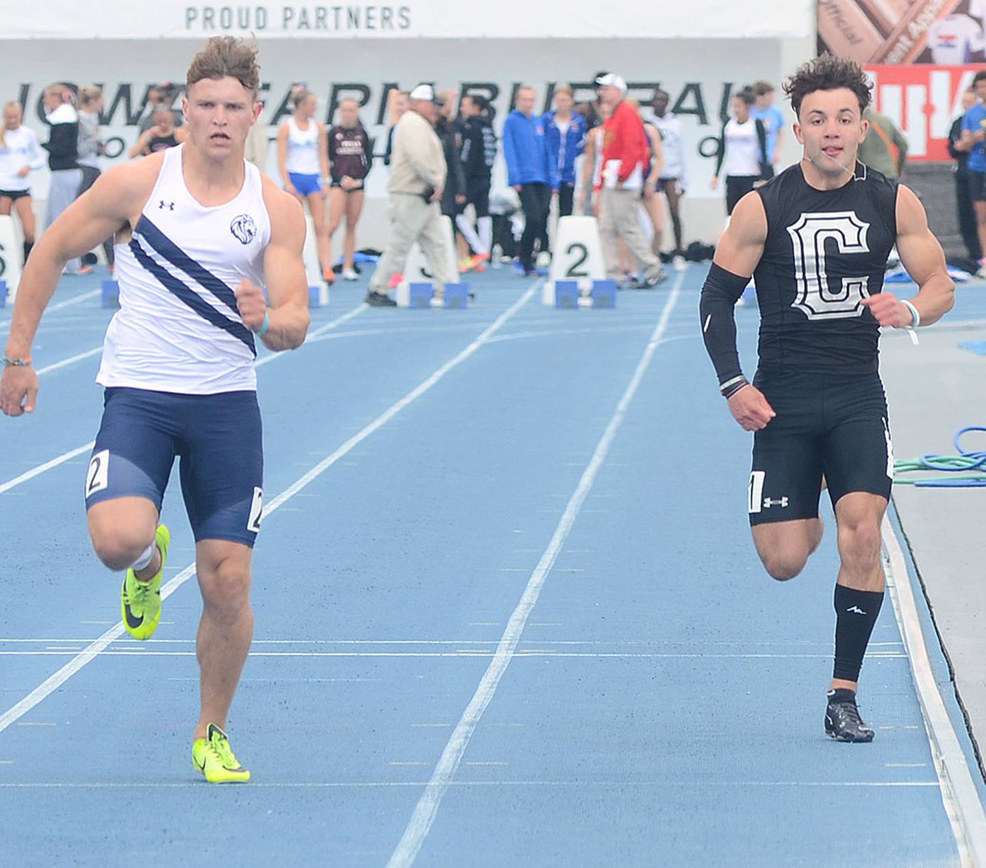 Seth Gordon of Creston (right) runs the 100 meters at Thursday's session of the state track and field championships. Gordon placed 19th in 11.21. He also qualified in the 200 meters.