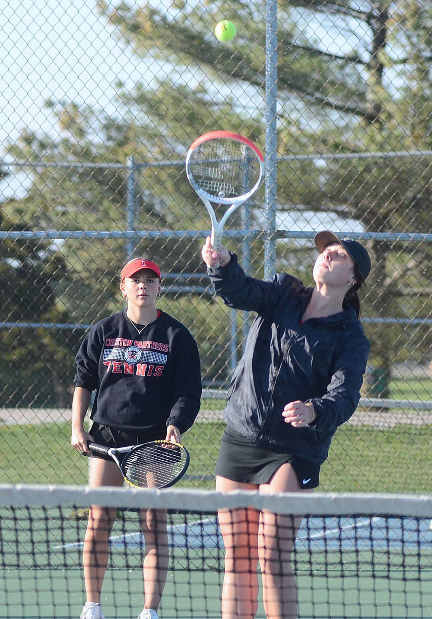 Kennedy Strider of Creston reaches for a volley at the net during No. 2 doubles action against Chariton Monday. Strider and Ava Adamson won the match, 8-1.