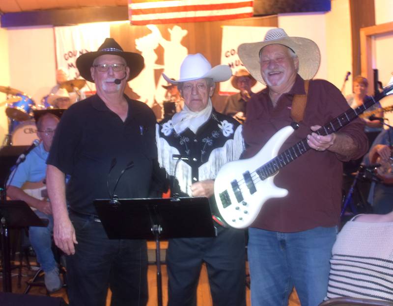 Ted Moran, center, poses with friends at The Chicken Inn on his 99th birthday, July 30. Moran is a weekly visitor at The Chicken Inn, where he both sings and dances.
