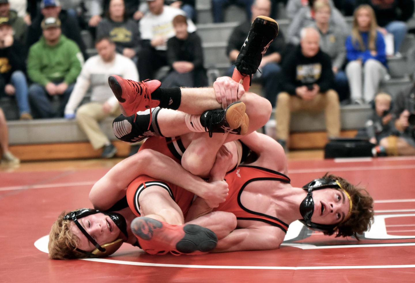 No. 1 Vinny Mayberry (left) of Glenwood and No. 4 Christian Ahrens (right) of Creston face off in a 120-pound exhibition Tuesday. Ahrens hung on for a 4-3 decision.