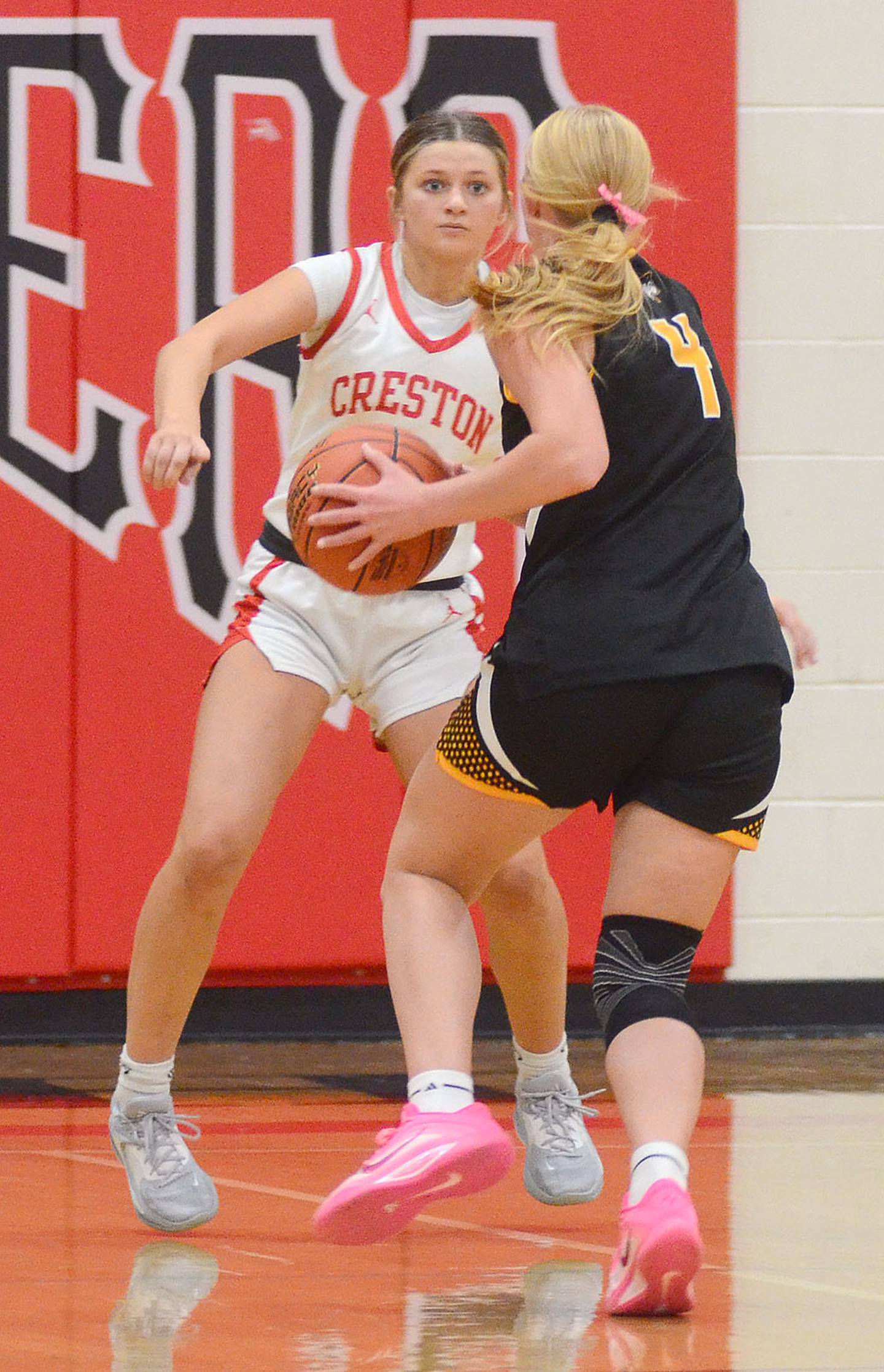 Creston sophomore Jensan Tussey concentrates while defending Winterset's Natalie Smith (4). Smith had 23 points and nine rebounds in lifting Winterset to the 77-48 win.