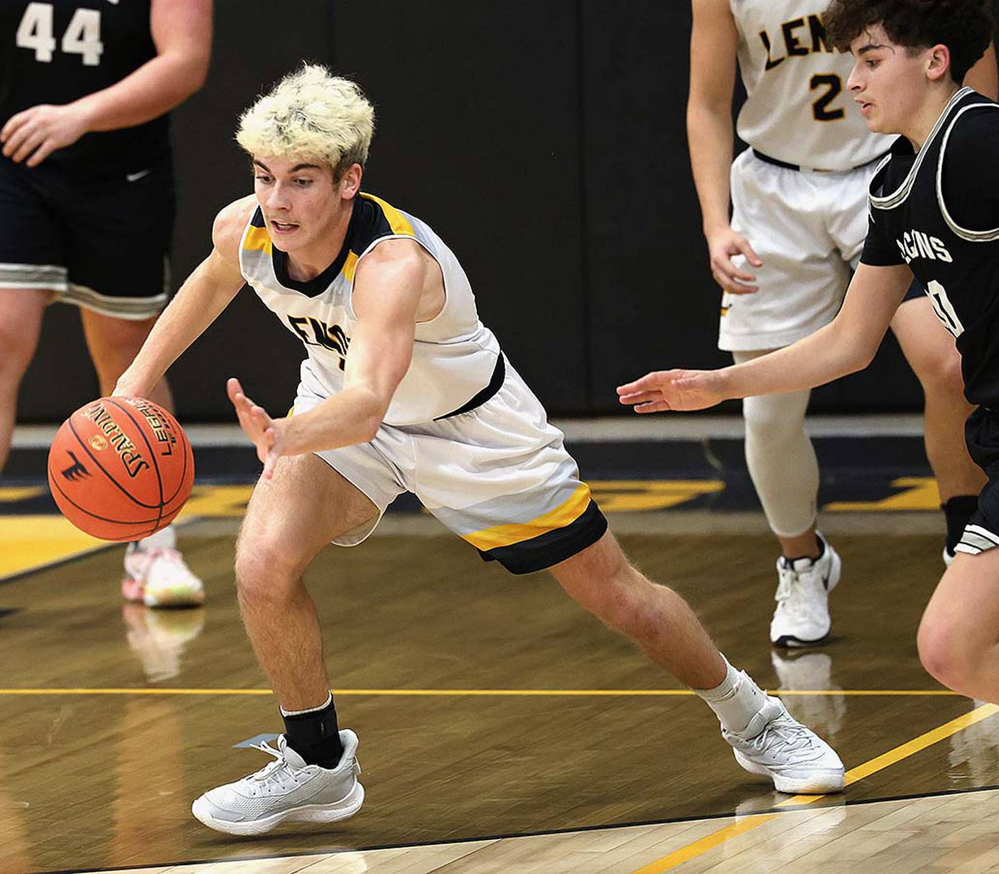 Gabe Funk reaches to intercept a pass on the basketball court. Funk holds the career steals record at Lenox (138) and has the career scoring record of 1,645 points.