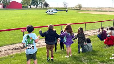 Orient helicopter pilot flies in to talk to students
