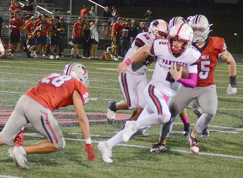 Creston quarterback Tanner Ray eludes a tackler at Harlan Friday. Ray leads the team in rushing with 582 yards and ranks fourth in Class 4A passing with 1,167 yards on 99 completions with three touchdowns.