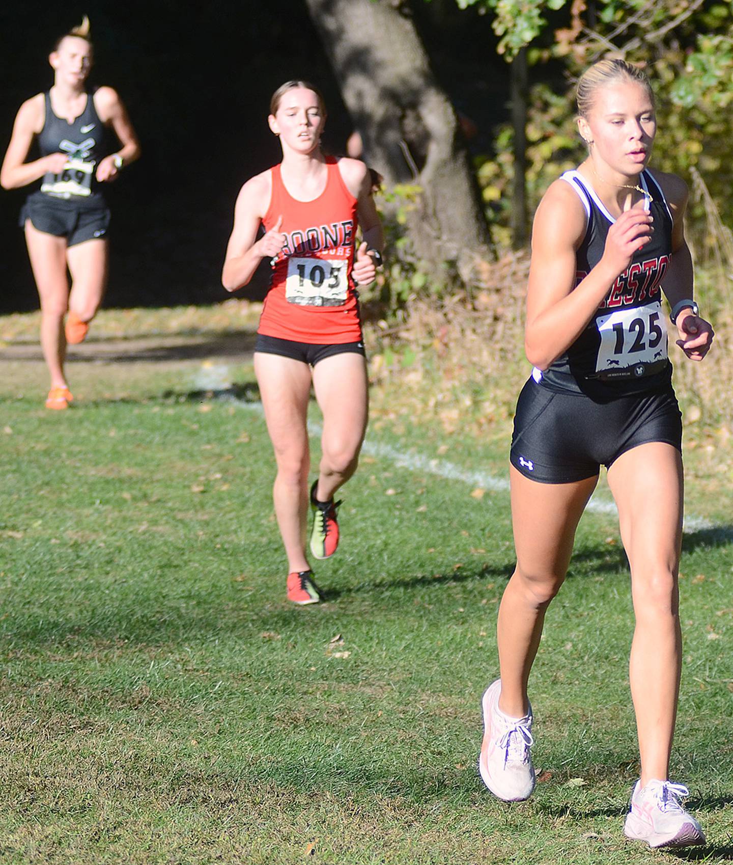 Creston sophomore Cora Smith (125) completes a curve in the wooded portion of Wednesday's 5K state qualifying race on the Central College Campus. Smith placed 18th in 20:52.87.