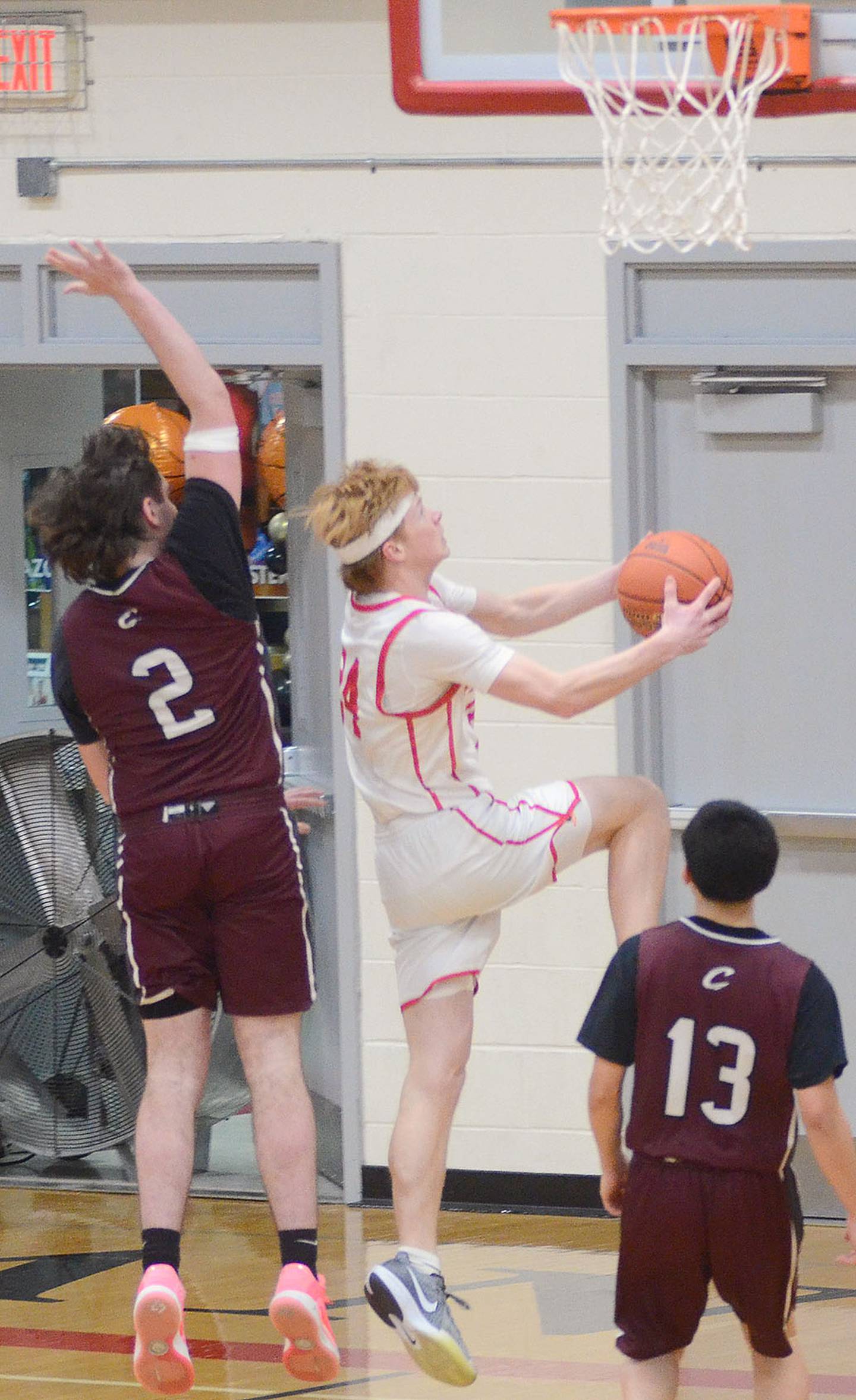 Tanner Ray of Creston drives for a reverse layup against Clarke's Ryan Diehl. Ray had three points and three assists in the Panther victory.